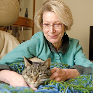 Pamela Schreiner petting her cat.