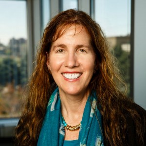 Dianne Neumark-Sztainer smiling with office windows behind her.