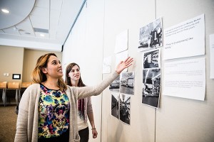 Brand - Creative two women looking at pictures on the wall