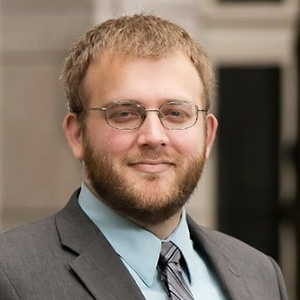 JP Leider wearing a gray suit.