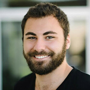 Morgan White wearing a black shirt and smiling.