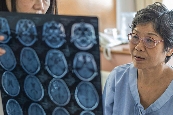 old woman hospital patient looking at x-rays