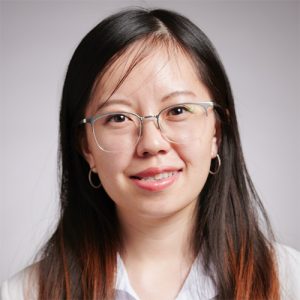 Serena Xiong in a white shirt and glasses smiling.