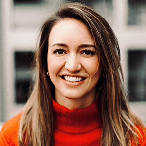 Brooke Dressen smiling while wearing a red sweater.