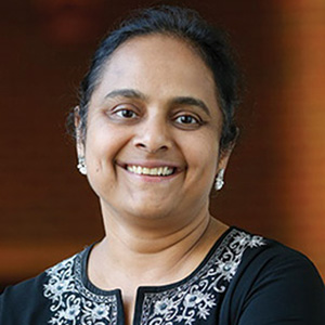 Sripriya Rajamani wearing a black top and smiling.
