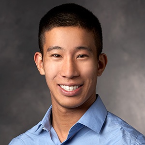 Jason Nagata smiling while wearing a blue dress shirt.