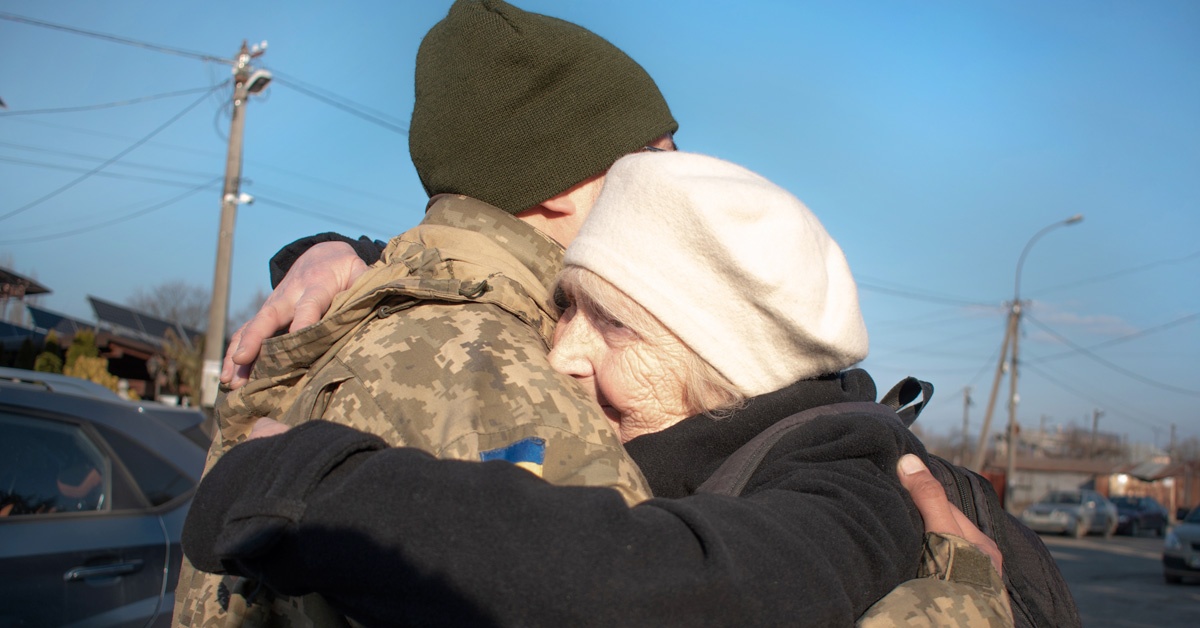Ukrainian solider and old person hugging