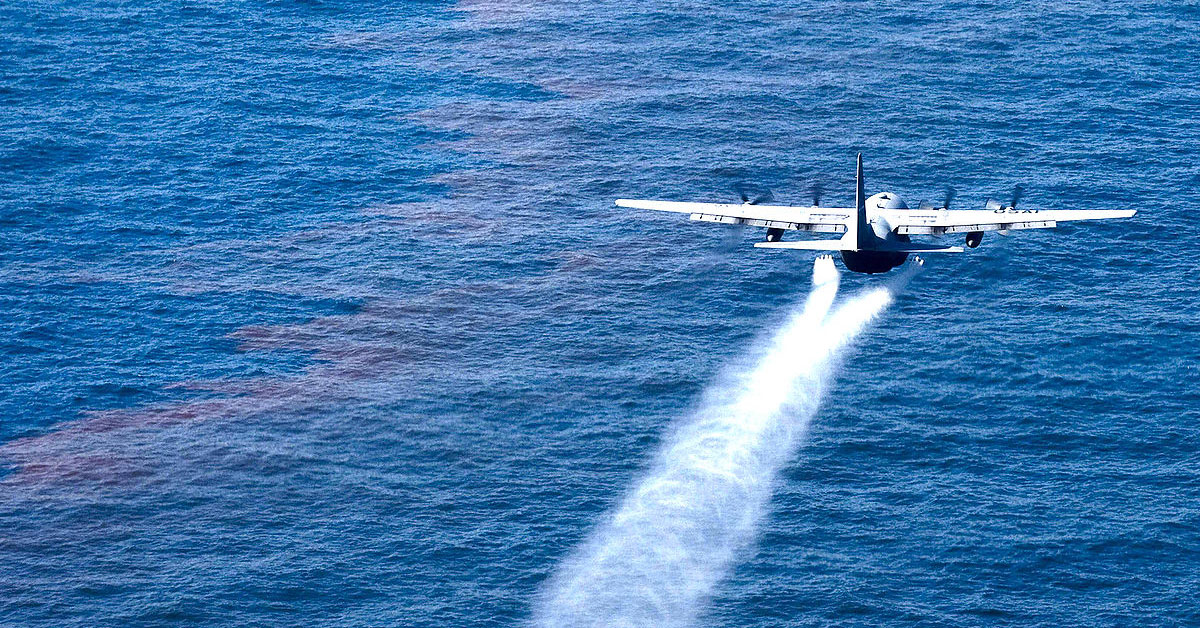 big airplane over oil spill