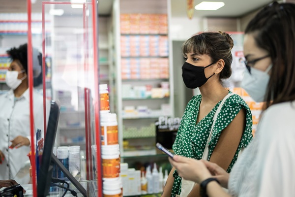 people standing waiting for their prescriptions
