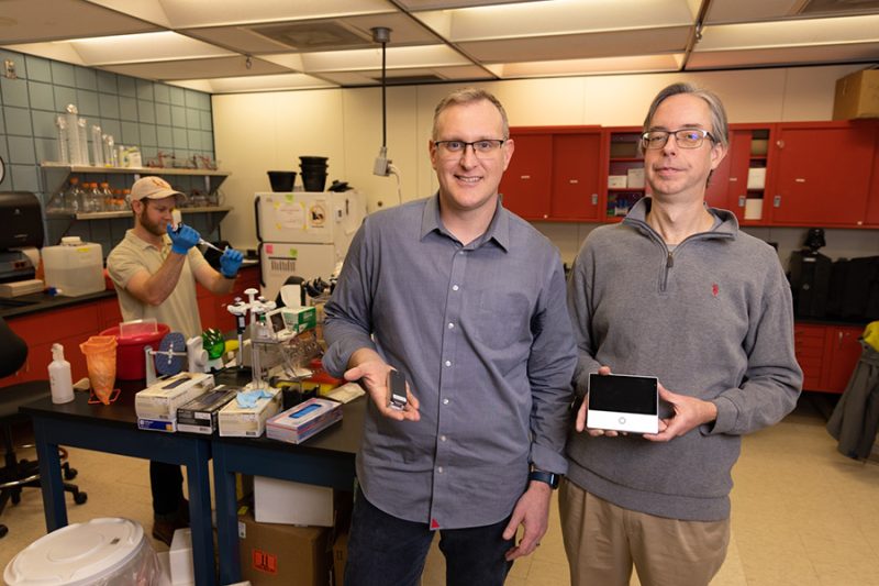 researchers (Jon Oliver) in tick lab