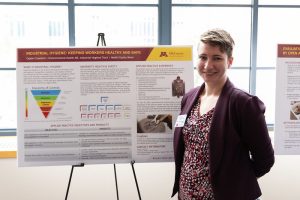 Environmental Health Sciences Student Caylin Crawford in front of one of her research presentations