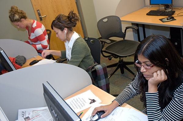 Students on computers in the SPHere lounge