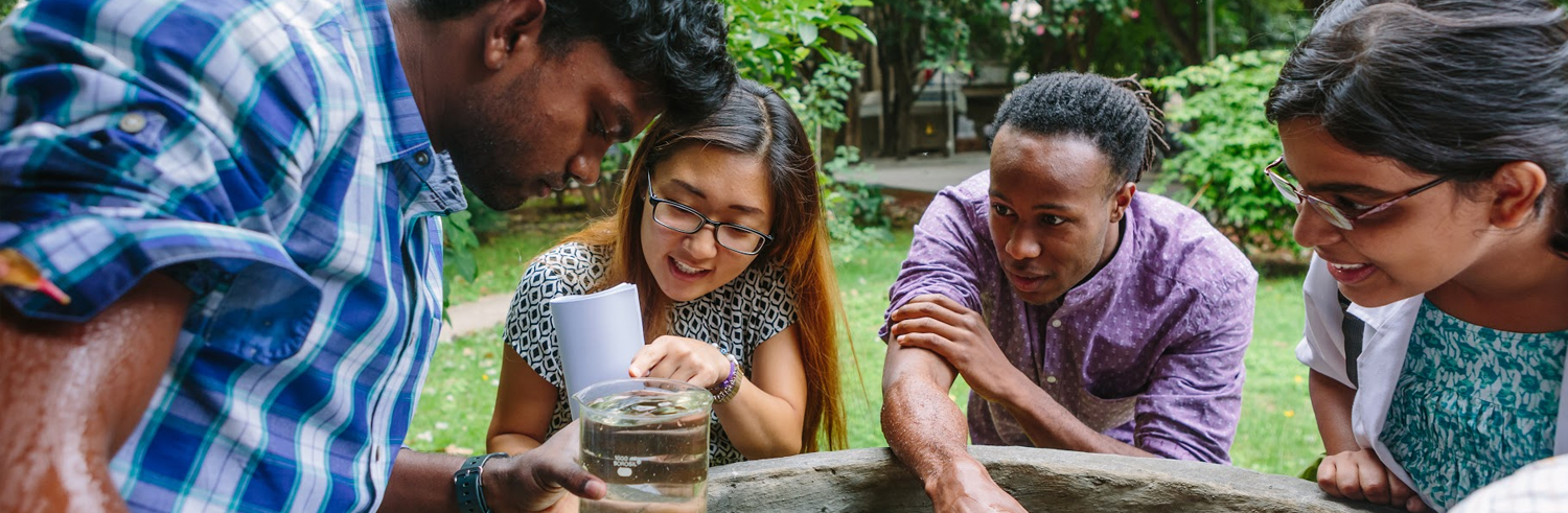 Students looking at a beaker