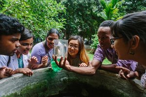 students looking at beaker