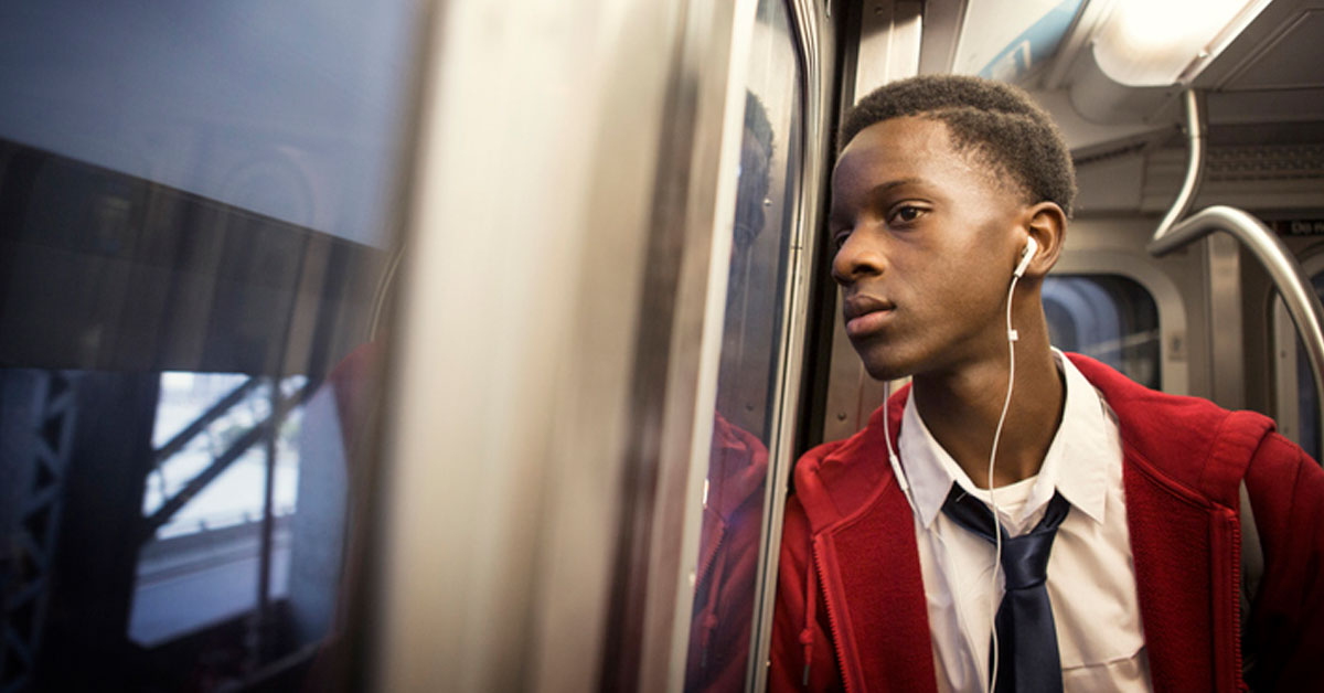 young person of color on train.