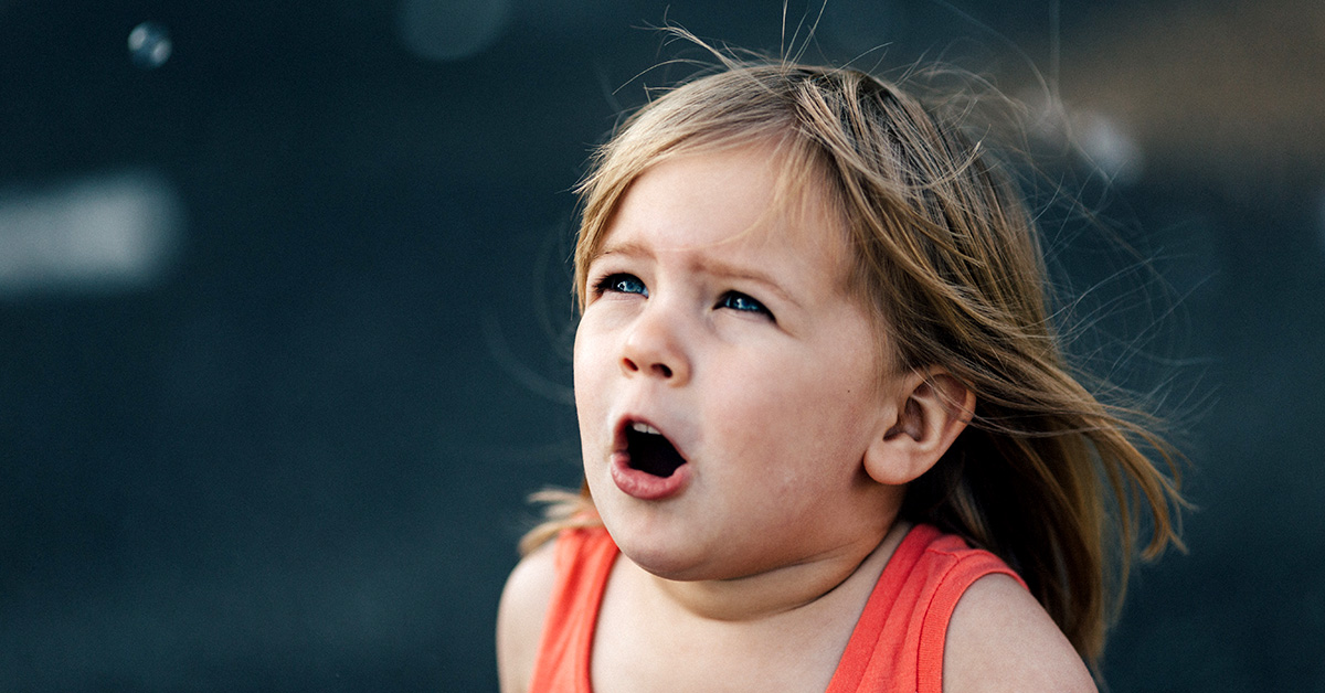 child in awe over bubbles