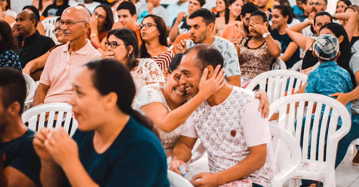 A large gathering of people sitting in chairs.