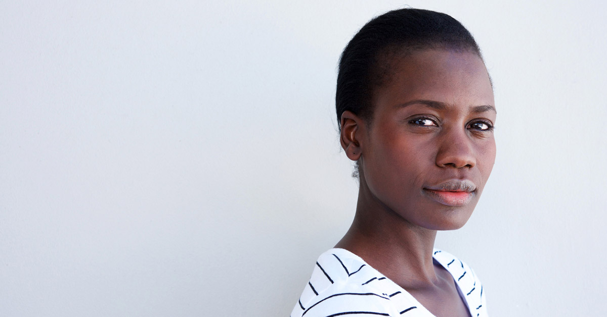 Close up portrait of attractive young black woman with serious expression