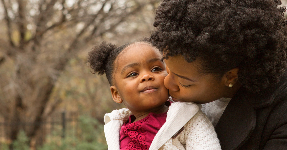 Happy African American mother and her daughter.