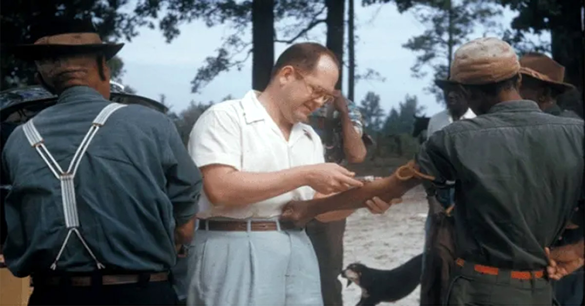 A man takes a blood sample from the arm of a Tuskegee resident.