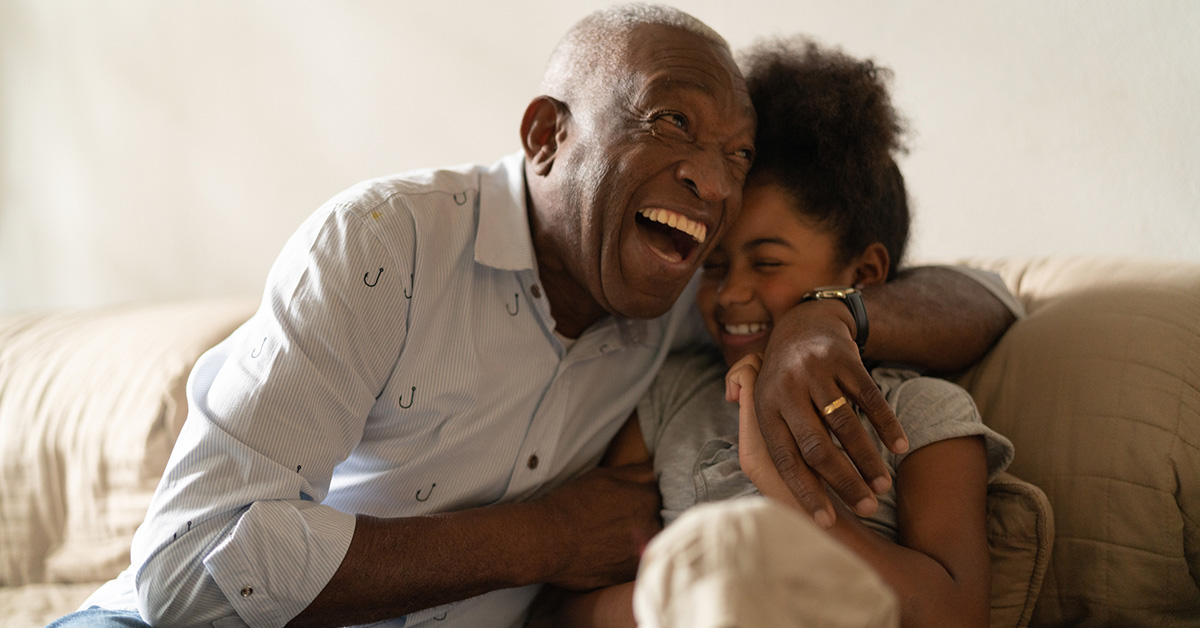 Grandfather playing with his granddaughter at home