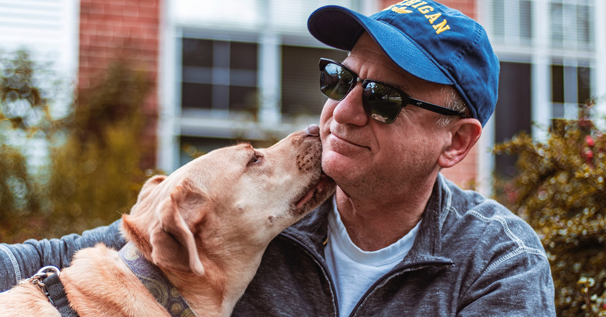 A dog licking a man's face.