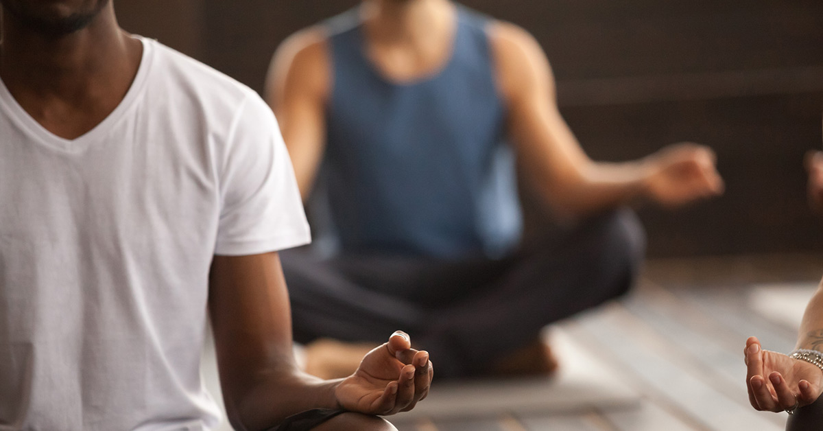 A group practices yoga together in a studio.