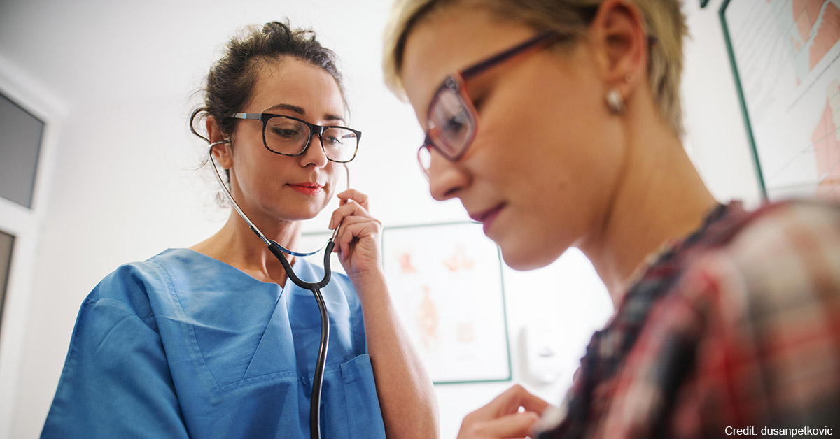 A nurse practitioner examining a patient.