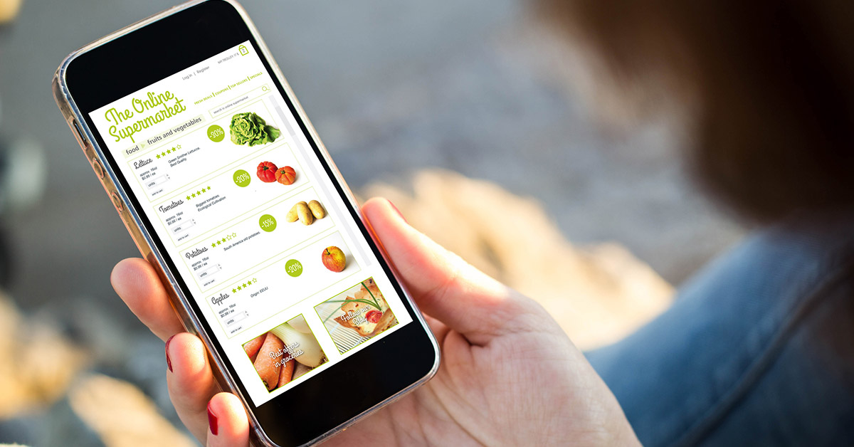 Woman using a phone to order groceries.