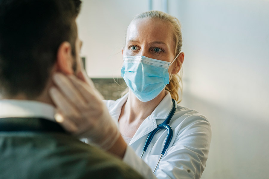 doctor in mask tending to patient