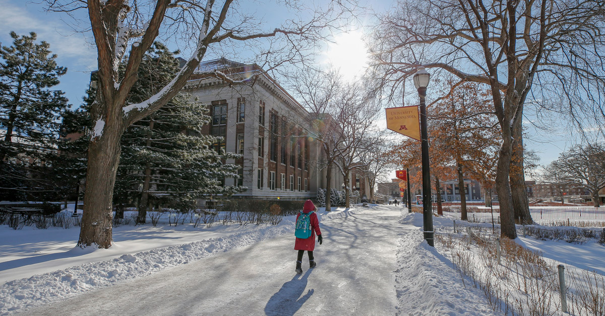 student walking on snowy u of m campus