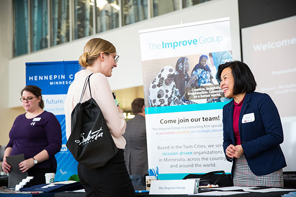 Woman talking to another woman at employer booth