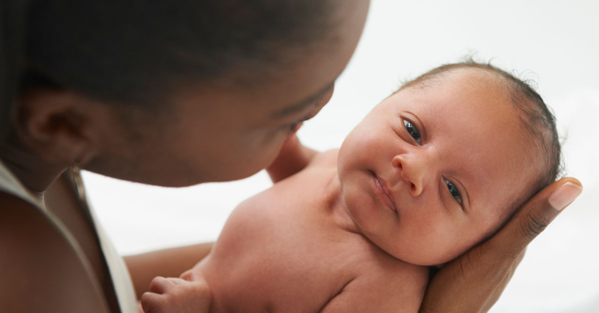 adult looking at baby