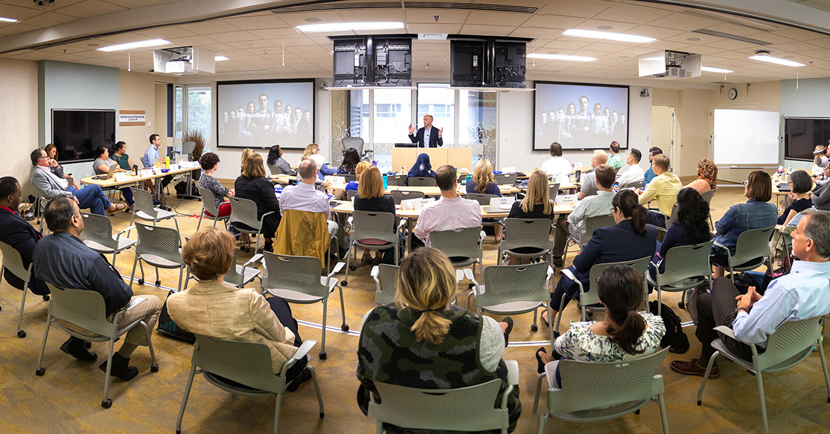 A classroom full of MH students listening to an instructor teach from the front of the room.