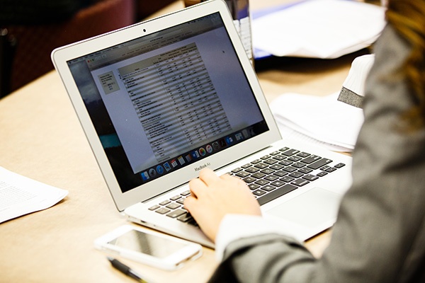 person typing at laptop.