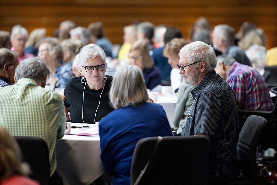 Conversation at a table at the Age Friendly Day event