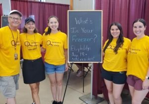 Lexi at Driven to Discover at the MN State Fair with colleagues in EnHS