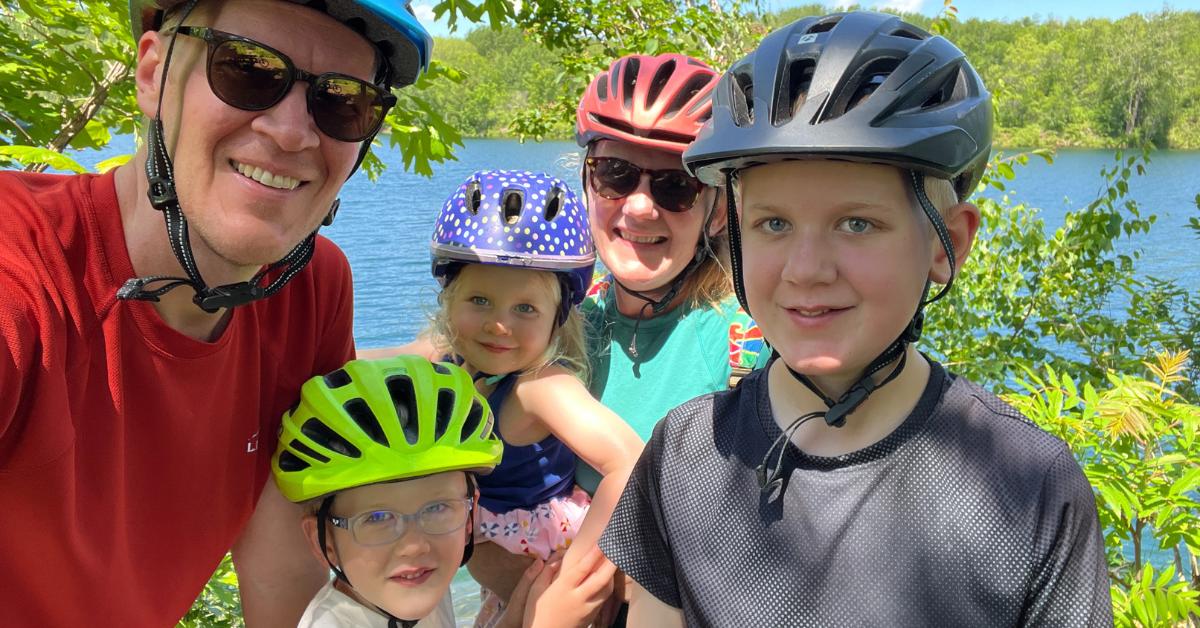 bjorn berg and family smiling with bike helmets on