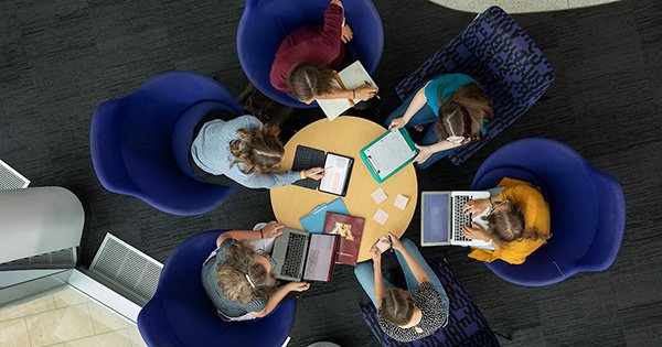 hp-small-feature-virtual-session top down view of students collaboratively working at a small round table