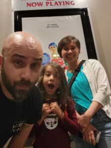 Harrison, his daughter Ruby, and his wife Tran watching a movie