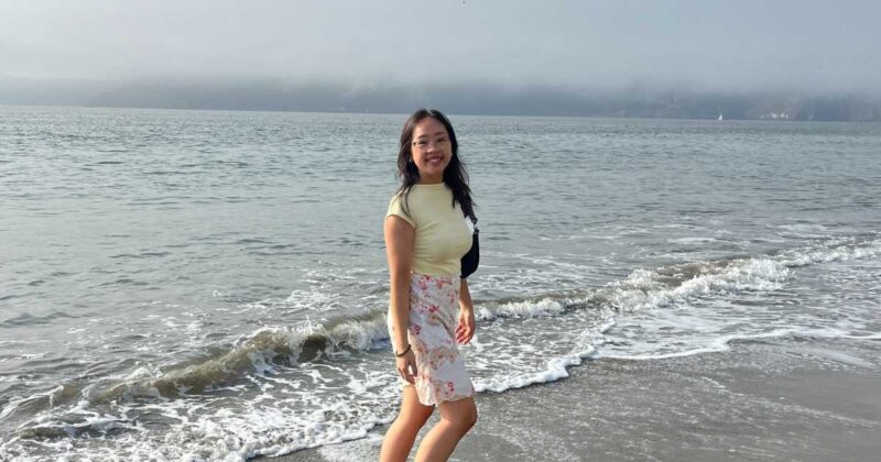 Eve Her standing in the ocean smiling