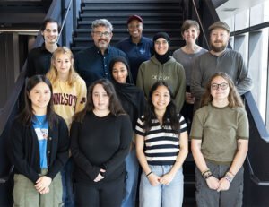 Group shot of several students and instructors standing on a staircase