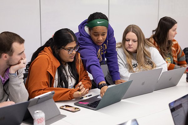 what-is-mph students looking at laptops