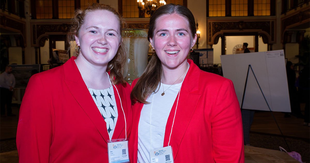 Kara Cowell on the left and Mary Kenny on the right wearing red jackets and smiling
