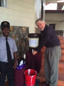 Jim Neaton in Monrovia at one of the handwashing stations that were outside every public building during the Ebola epidemic. Photo courtesy of Jim Neaton 