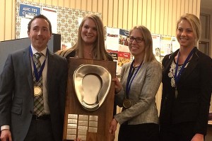 MHA students Spencer Cahoon and Rachel Uitti (left) with CLARION teammates Michelle Rundquist (pharmacy) and Stephanie Jamsa (dentistry). The CLARION trophy is a bedpan, an object the founders of the competition found fitting to represent health and patient care. 