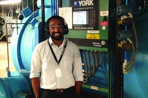 University of Washington student and MnTAP intern Daniel Sales with one of IBM’s HVAC systems. Photo by Brian Morgan