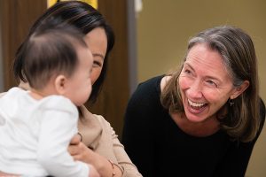 MILK Study coordinator Laurie Foster with a mom and baby at a six-month check up.